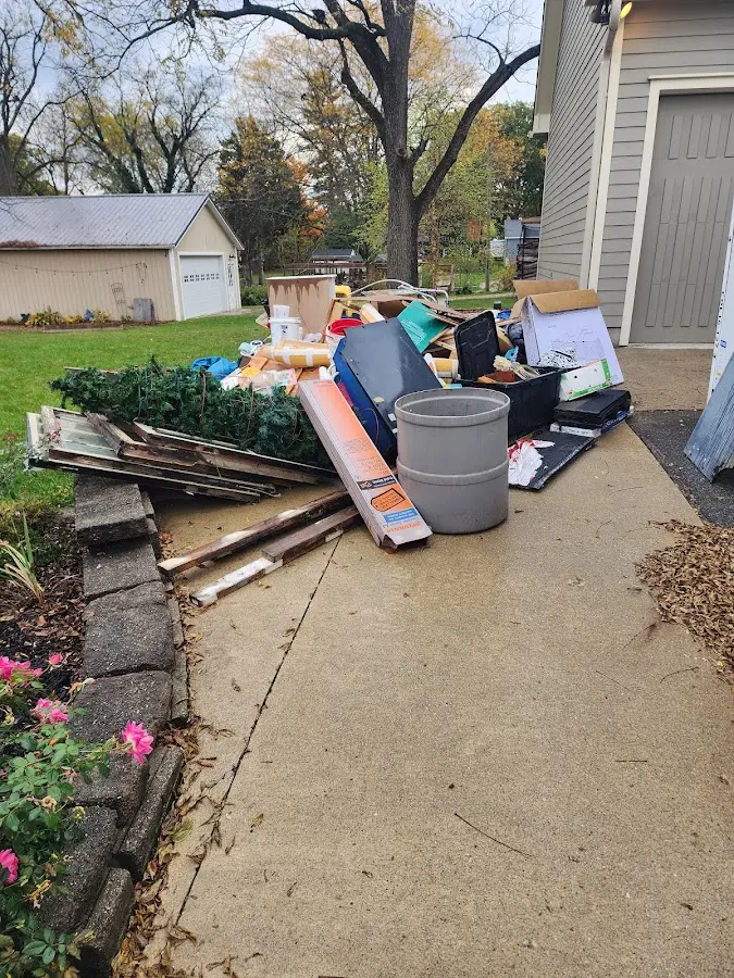 Dumpster being loaded with debris for Roofing Dumpster Rental in Five Corners
